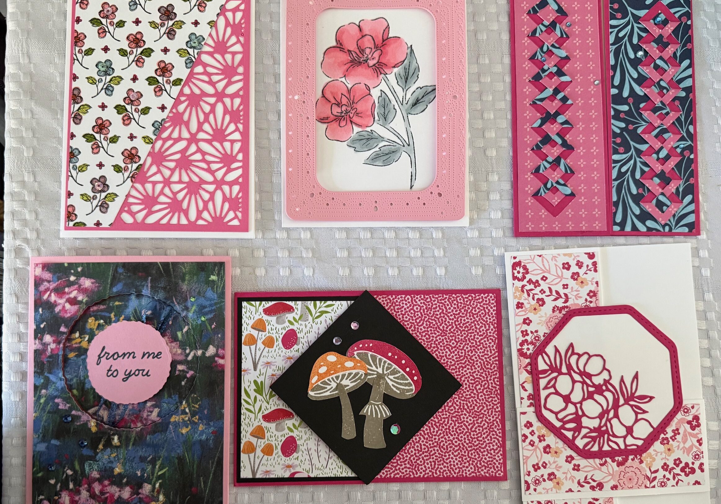 a collection of six greeting cards, each different styles and folds , all featuring pink decorative papers , pictures and embellishments.