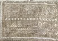 Rolled hand embroidered travel sewing kit displaying the stitcher's initials and year of completion